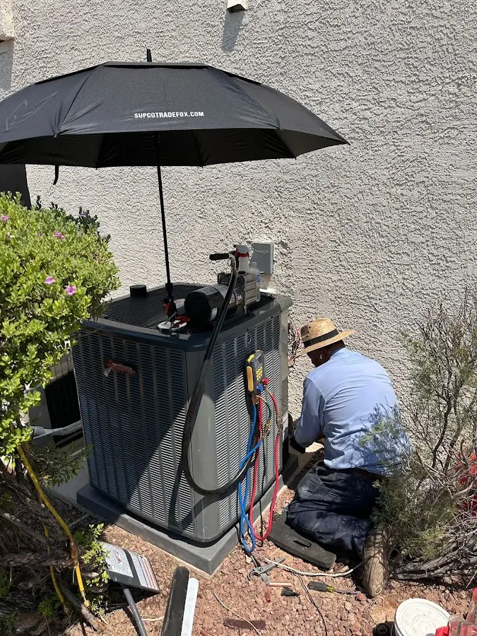HVAC technician performing outdoor AC maintenance in Fairwood